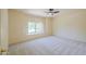 Bedroom features carpeted floor, ceiling fan, bright window with plantation shutters, and neutral walls at 695 W Estrella Dr, Gilbert, AZ 85233