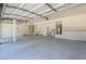 Large garage featuring an opener, water heater, freezer, and ample storage space at 695 W Estrella Dr, Gilbert, AZ 85233