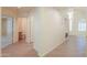 Hallway with tiled floor provides access to multiple rooms and features neutral paint tones at 695 W Estrella Dr, Gilbert, AZ 85233