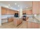 Spacious kitchen featuring granite countertops and updated, stainless steel appliances at 695 W Estrella Dr, Gilbert, AZ 85233