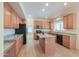 Well-lit kitchen with a center island, granite counters, and ample cabinetry at 695 W Estrella Dr, Gilbert, AZ 85233