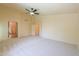 Spacious main bedroom featuring plush carpet, ceiling fan, and ensuite access at 695 W Estrella Dr, Gilbert, AZ 85233