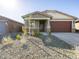 Well-maintained single-story home with drought-resistant landscaping, a two-car garage, and stone accents at 16073 W Cottontail Ln, Surprise, AZ 85387