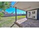 Spacious backyard features a covered patio with stone flooring, perfect for outdoor entertaining at 3801 E Captain Dreyfus Ave, Phoenix, AZ 85032