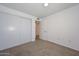 This cozy bedroom features neutral carpet, a spacious closet, and ample natural light at 3801 E Captain Dreyfus Ave, Phoenix, AZ 85032