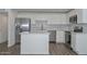 Modern kitchen features stainless steel appliances, white cabinets, countertops and a center island at 3801 E Captain Dreyfus Ave, Phoenix, AZ 85032