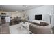 Bright living room with modern furniture, a rug, and an open-concept layout to the kitchen and dining room at 3801 E Captain Dreyfus Ave, Phoenix, AZ 85032