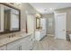 Bright bathroom featuring dual sinks, granite countertops, white cabinetry, and neutral paint at 19575 E Vallejo St, Queen Creek, AZ 85142