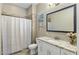 Bright bathroom featuring granite counters, white cabinetry, and neutral tile at 19575 E Vallejo St, Queen Creek, AZ 85142