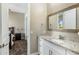 Bright bathroom featuring granite counters, white cabinetry, and neutral tile with a view to another bedroom at 19575 E Vallejo St, Queen Creek, AZ 85142