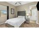 Cozy bedroom with a tufted headboard, neutral walls, and natural light streaming through the window at 19575 E Vallejo St, Queen Creek, AZ 85142