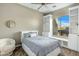 Inviting bedroom with built-in bookshelves, a window seat, and serene decor at 19575 E Vallejo St, Queen Creek, AZ 85142