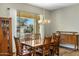 Dining room with wood table set looking out onto a stunning pool and mountain view at 19575 E Vallejo St, Queen Creek, AZ 85142