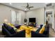 Stylish living room featuring modern furniture and a neutral color scheme with yellow accents at 19575 E Vallejo St, Queen Creek, AZ 85142