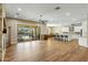 Open-concept living area with fireplace, tile floors, backyard access, and seamless flow into kitchen and dining at 19575 E Vallejo St, Queen Creek, AZ 85142