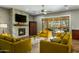 Cozy living room with a stone fireplace, wood floors, and comfortable seating arrangements at 19575 E Vallejo St, Queen Creek, AZ 85142