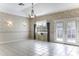 Bright living room featuring tile floors, ample natural light, and backyard access creates a serene atmosphere at 8209 W Raven Dr, Arizona City, AZ 85123