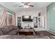 Open living room with a sectional sofa and view into kitchen at 16567 W Mckinley St, Goodyear, AZ 85338