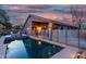 Stunning pool and spa area with string lights, creating an evening ambiance at 16567 W Mckinley St, Goodyear, AZ 85338