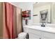 Bright bathroom featuring a white vanity, neutral color shower curtain and towel rack at 2432 E Gleneagle Dr, Chandler, AZ 85249