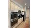 Modern kitchen appliances including double ovens, stainless refrigerator, and white cabinets at 4142 E Zion Pl, Chandler, AZ 85249