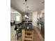 Gourmet kitchen with a large island, stainless steel appliances, and views into the dining and living areas at 4142 E Zion Pl, Chandler, AZ 85249