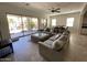 Spacious living room with a large sectional, tile flooring, and access to the outdoor patio with a pool at 4142 E Zion Pl, Chandler, AZ 85249