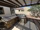 Outdoor kitchen with a built-in stainless steel grill and stone facade, perfect for outdoor entertaining and gatherings at 4142 E Zion Pl, Chandler, AZ 85249