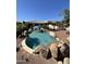 Backyard oasis with a sparkling pool, rock waterfall, and inviting patio area at 4142 E Zion Pl, Chandler, AZ 85249