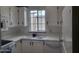 Bright kitchen featuring white cabinets, white countertops, and a stainless steel sink and microwave at 17200 W Bell Rd # 1637, Surprise, AZ 85374