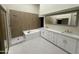 Elegant bathroom with a soaking tub, shower, and double vanity at 9214 W Kerry Ln, Peoria, AZ 85382