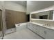 Spa-like bathroom featuring a soaking tub, walk-in shower, and dual sinks at 9214 W Kerry Ln, Peoria, AZ 85382