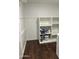Clean laundry room features wood-look floors and painted shelving for storage at 19202 N Signal Butte Cir, Sun City, AZ 85373