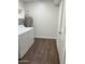 Cozy laundry area with white appliances, storage and vinyl wood flooring at 19202 N Signal Butte Cir, Sun City, AZ 85373