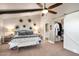 Bright bedroom with vaulted ceilings, ceiling fan, modern lighting, decor, and a sliding door to the ensuite at 23006 N 86Th St, Scottsdale, AZ 85255