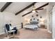 Spacious bedroom featuring vaulted ceilings with wood beams, a ceiling fan, and neutral tones with soft natural light at 23006 N 86Th St, Scottsdale, AZ 85255