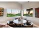 Cozy breakfast nook features a round table, leather chairs and view of the lush landscaping and Arizona sunset at 23006 N 86Th St, Scottsdale, AZ 85255