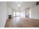 Open living room featuring wood flooring, modern fireplace, and door to another room at 4525 N 22Nd St # 404, Phoenix, AZ 85016