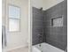 Clean bathroom with a bathtub and gray tiled shower at 23120 W Skinner Rd, Wittmann, AZ 85361