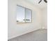 Simple bedroom with gray carpet, ceiling fan, and a window at 23120 W Skinner Rd, Wittmann, AZ 85361