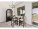 Small breakfast nook with dark wood table and chairs, and an arched cabinet at 23120 W Skinner Rd, Wittmann, AZ 85361