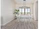 Light and airy dining room with hardwood floors and a large window at 23120 W Skinner Rd, Wittmann, AZ 85361