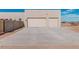 Two-car garage, light colored stucco home at 23120 W Skinner Rd, Wittmann, AZ 85361