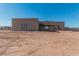 Rear view of stucco home on desert lot at 23120 W Skinner Rd, Wittmann, AZ 85361