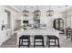 Spacious kitchen boasts a large island, white cabinets, and modern pendant lighting at 23120 W Skinner Rd, Wittmann, AZ 85361