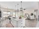 Open concept kitchen with white island, stainless steel appliances, and wood-look floors at 23120 W Skinner Rd, Wittmann, AZ 85361