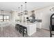 Modern kitchen with white island, stainless steel appliances, and wood-look floors at 23120 W Skinner Rd, Wittmann, AZ 85361