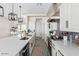 Modern kitchen with white cabinets, long countertops, and gray backsplash at 23120 W Skinner Rd, Wittmann, AZ 85361