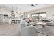 Bright living room features light gray sofas, wood-look floors, and large windows at 23120 W Skinner Rd, Wittmann, AZ 85361
