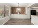 Inviting dining area featuring a decorative stone accent wall and built-in cabinets at 9502 W Mcrae Way, Peoria, AZ 85382